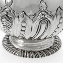 A curved oblong silver spirit flask with detachable gilt cup.